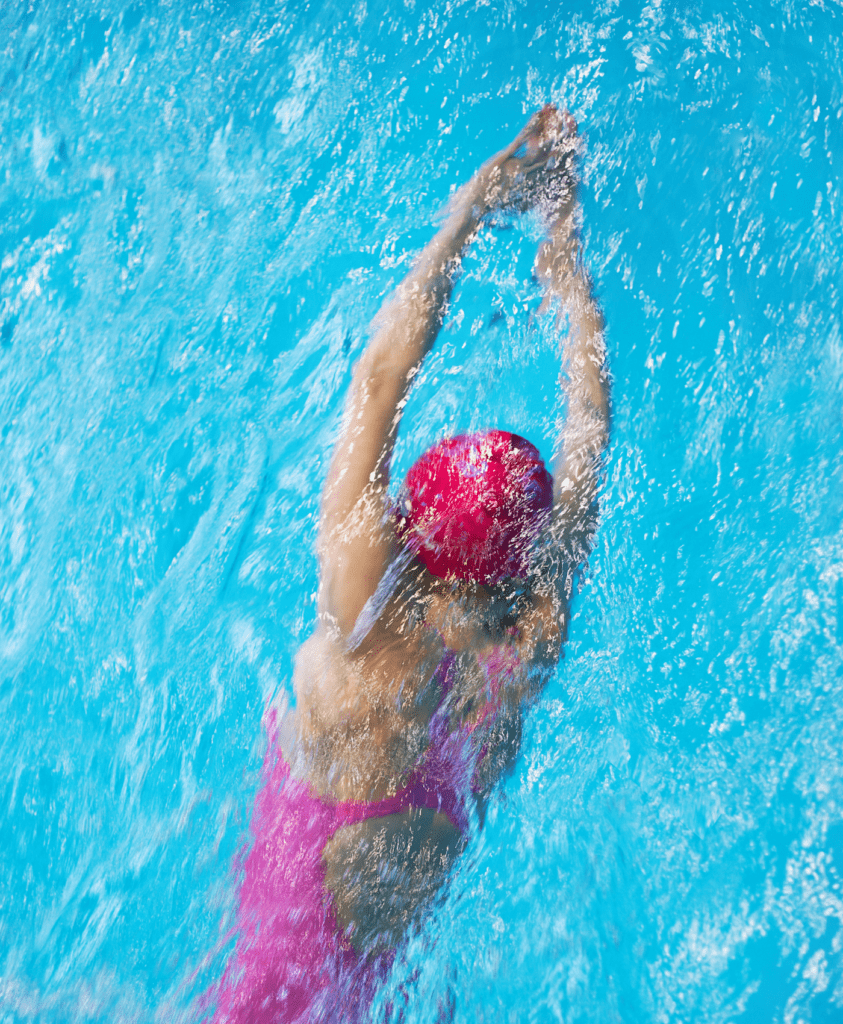 Women Only Swimming - Woman in pink swimsuit swimming hat in swimming pool